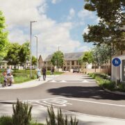 Artist’s impression of a modern residential street in Kinnegad featuring new A-rated houses, landscaped green spaces, trees, pedestrians and cyclists in a family-friendly estate layout.