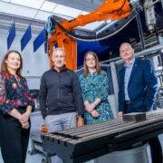Irish Manufacturing Research (IMR) team in an advanced manufacturing laboratory with industrial robotics, showcasing AI, automation, innovation and digital transformation in Ireland's manufacturing sector.