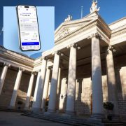Bank of Ireland's new mobile banking app displayed on a smartphone screen with the Bank of Ireland headquarters in Dublin in the background, highlighting the bank's digital banking transformation, enhanced security features and improved customer experience.