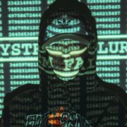 Cybersecurity threat concept showing a hooded figure with digital code projections and system failure warning, representing cyber attacks, hacking risks and data breaches.