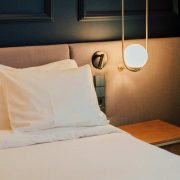 Modern hotel guest room featuring a neatly made bed, bedside table and ambient lighting, reflecting trends in Ireland’s hospitality and hotel accommodation sector in 2026.