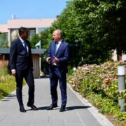Two men in suits walk through the Intel Ireland campus in Leixlip, County Kildare, as Intel announces a &euro;5 billion investment to expand semiconductor manufacturing capacity and AI chip production.
