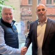 Representatives from Vault365 and Newcorp shaking hands following a UK partnership agreement to expand LocalLock immutable backup and data protection services across regulated sectors.