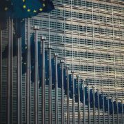 European Union flags outside an EU institution building, illustrating EU AI Act regulation, artificial intelligence compliance, governance rules and technology policy affecting Irish SMEs and businesses across Europe.