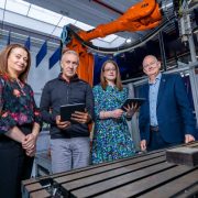 Irish Manufacturing Research team members with industrial automation equipment and robotic technology, showcasing AI adoption and digital transformation in Irish manufacturing.