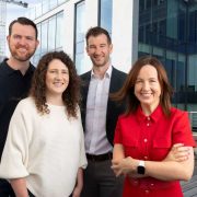 Group portrait of executives from an Irish technology company standing outside a modern office building following recognition in the Deloitte EMEA Technology Fast 500 rankings, highlighting Ireland's fast-growing tech sector and business innovation.