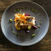 Gourmet fish dish served with roasted vegetables, beetroot and herb dressing on a restaurant plate, highlighting premium Irish food, fine dining and food and beverage industry trends.