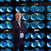John O'Connor of Culligan Ireland standing in front of rows of reusable water bottles at a Culligan facility as the company announces a multi-million-euro investment and 102 new jobs across Ireland.