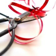 Scissors cutting red tape ribbon, symbolising efforts to reduce business costs, cut regulation and ease compliance burdens for Irish SMEs and businesses.