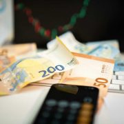 Euro banknotes, calculator, smartphone and computer keyboard illustrating financial planning, VAT changes, business costs, taxation and compliance challenges facing Irish SMEs in 2026.