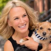 Agnes Stawosz of Dogville holding a small dog, highlighting the Cork-based luxury dog boarding, grooming and premium pet care business.