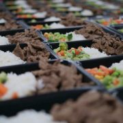 Healthy prepared meals featuring lean beef, rice and mixed vegetables arranged in trays, highlighting nutritious workplace catering and meal solutions for shift workers.