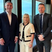Three business representatives at a Dublin office discussing SME growth finance and Ireland’s €1bn Growth and Sustainability Loan Scheme.