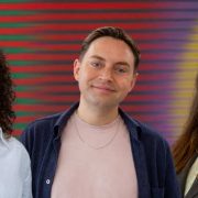 Three Conjure Communications team members pictured together against a colourful striped background in Dublin.