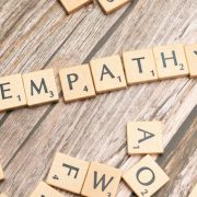 Wooden letter tiles spelling &ldquo;empathy&rdquo; on a rustic wooden surface, illustrating empathy and empathetic leadership.
