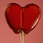 Red heart-shaped lollipop on a stick, illustrating leadership decision-making and finding the next right answer.