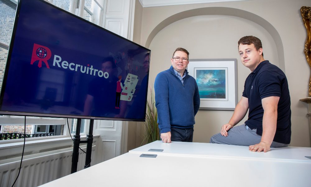 Two men in a boardroom.