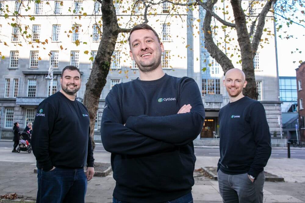 Three men in navy sweatshirts.