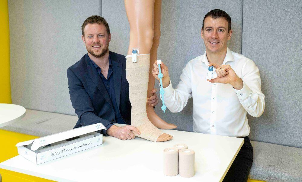 Two men demonstrating medtech for wounds.