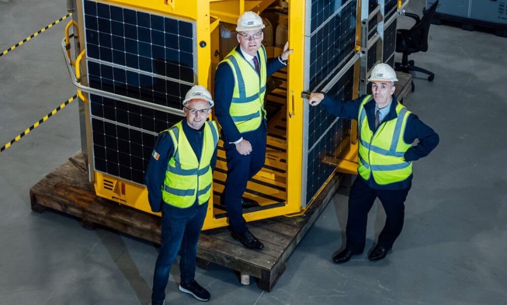 Three men beside a Green Rebel buoy.