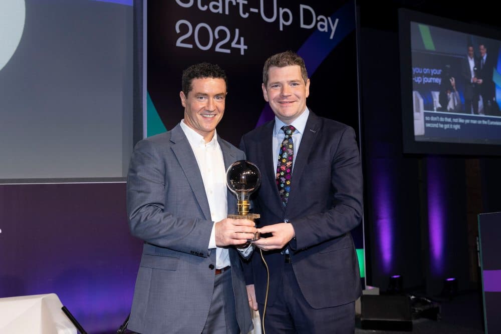 Men in suits holding an award.