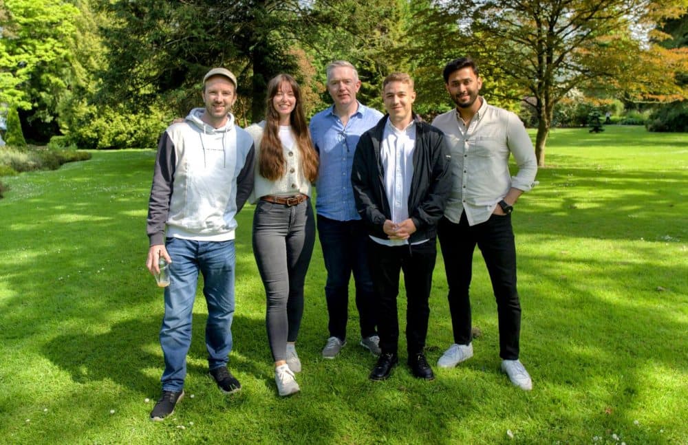 Four men and a woman in a park.