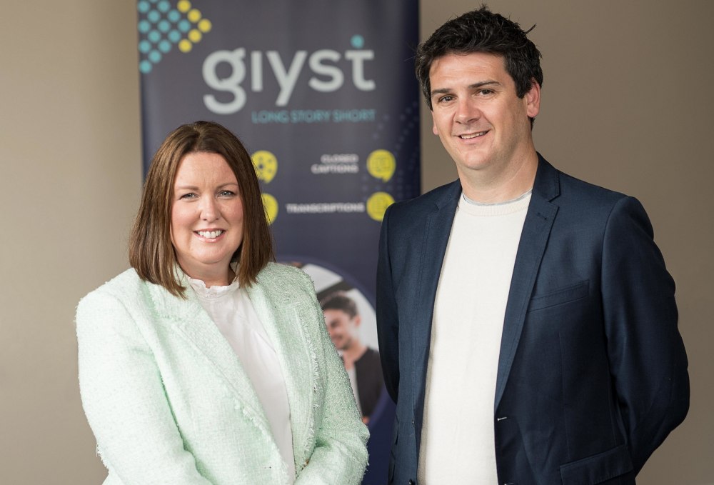 Woman in green jacket beside man in black jacket.