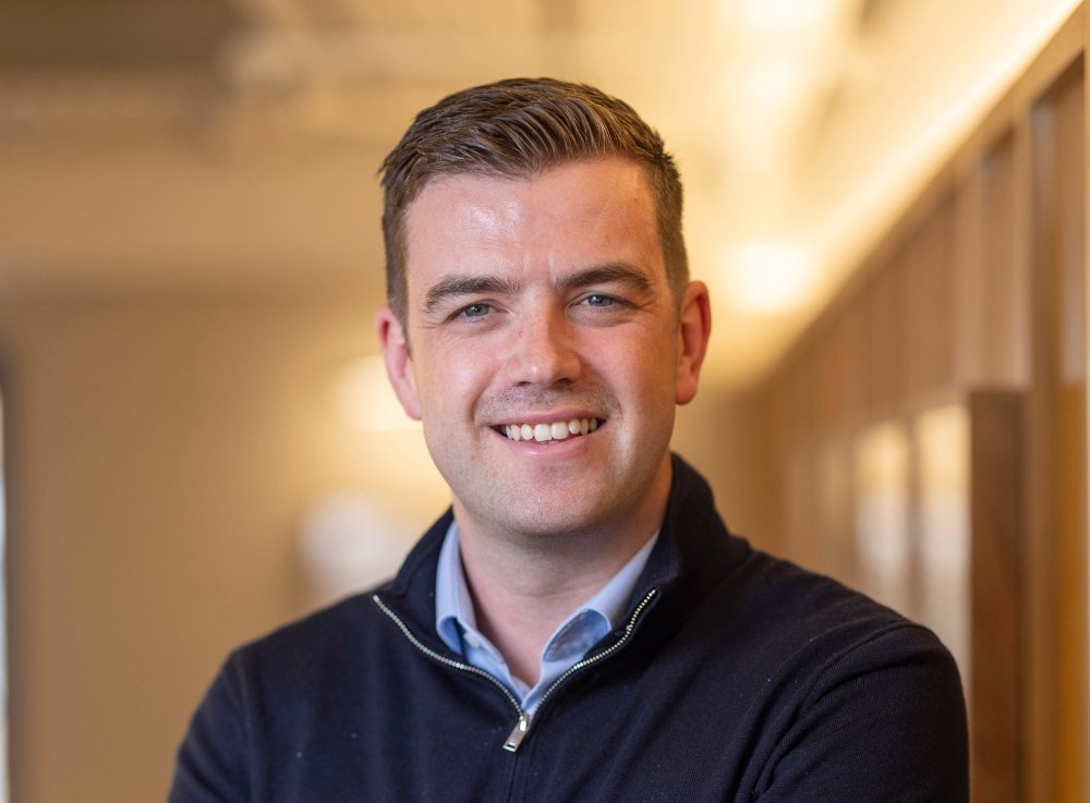 Smiling man with dark hair.