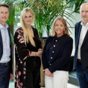 Two men and two women in business attire.
