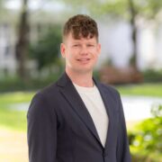 Young man wearing dark sports jacket.