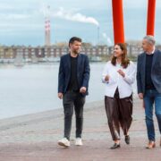 Two men and a woman walking at Silicon Docks in Dublin.