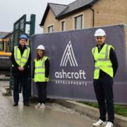 Two men and a woman in high vis outside a housing construction site in Louth.